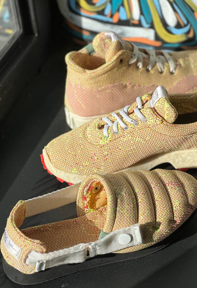 Photo of three 1/2 pairs of shoes on a black bench that are made from a quilted yellow an pink material