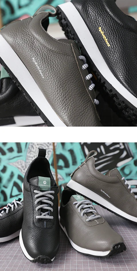 Profile shot of grey and black leather sneakers with a white midsole and black outsole. Bottom shoe shoes pairs of leather sneakers in black and grey with round black and white laces