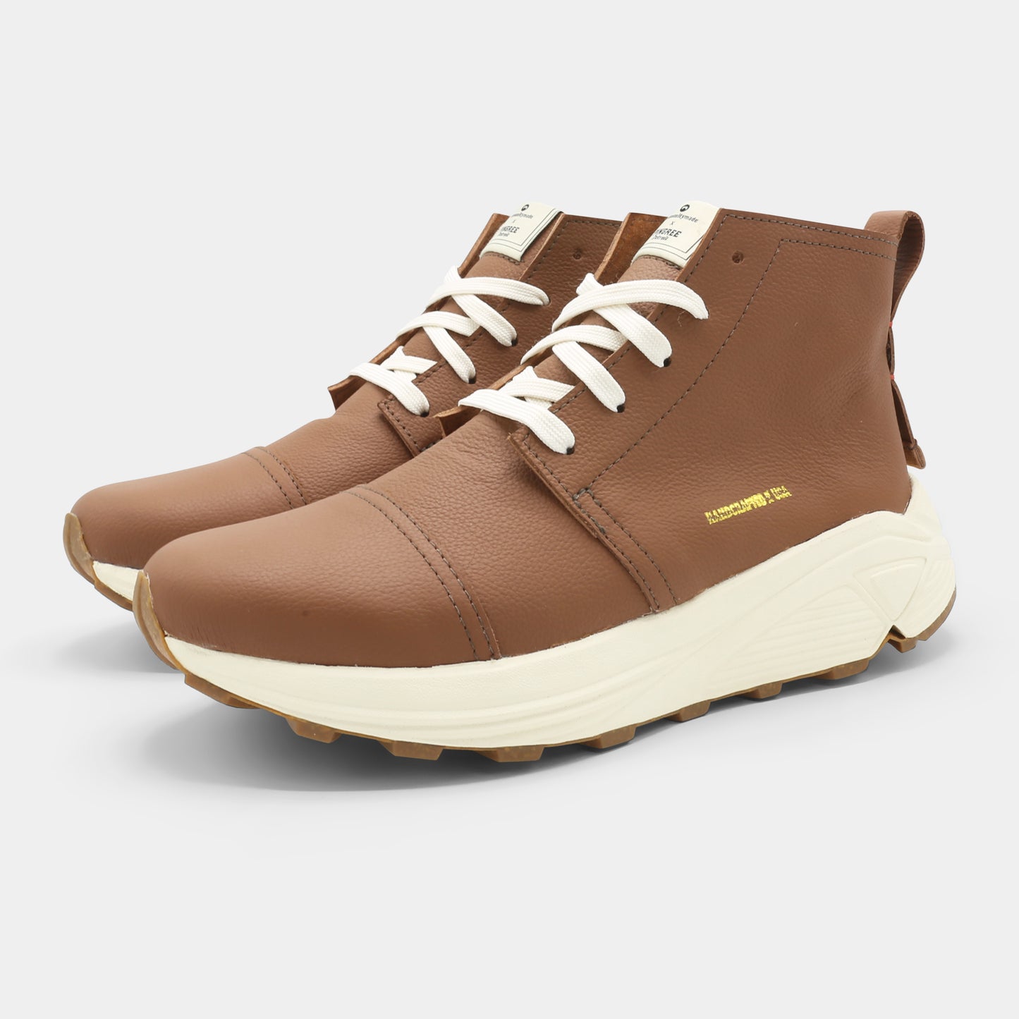 A brown high-top urban utility chukka boot with white laces and a chunky white sole lateral view.