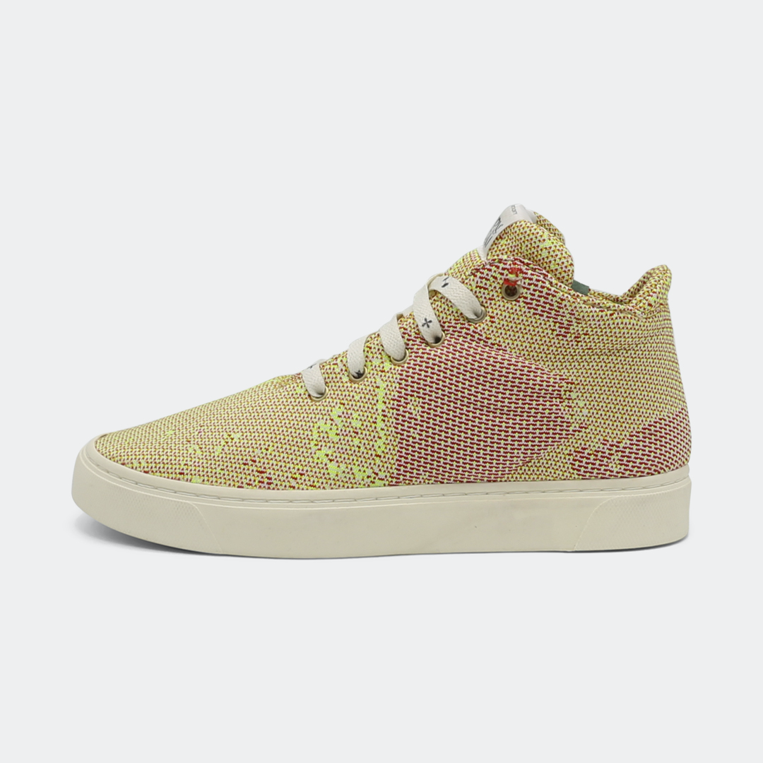 Mid-top sneakers with a camouflage pattern in yellow and pink colors, featuring lace-up closure lateral view